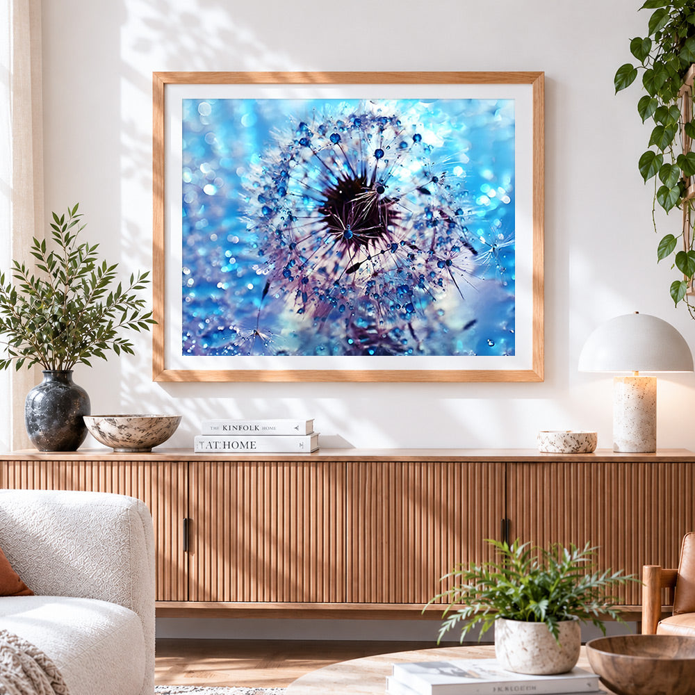 Finished blue dandelion with dew drops cross stitch artwork displayed