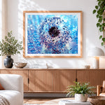 Finished blue dandelion with dew drops cross stitch artwork displayed