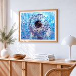 Blue dandelion with dew drops cross stitch artwork displayed on wall as home decor