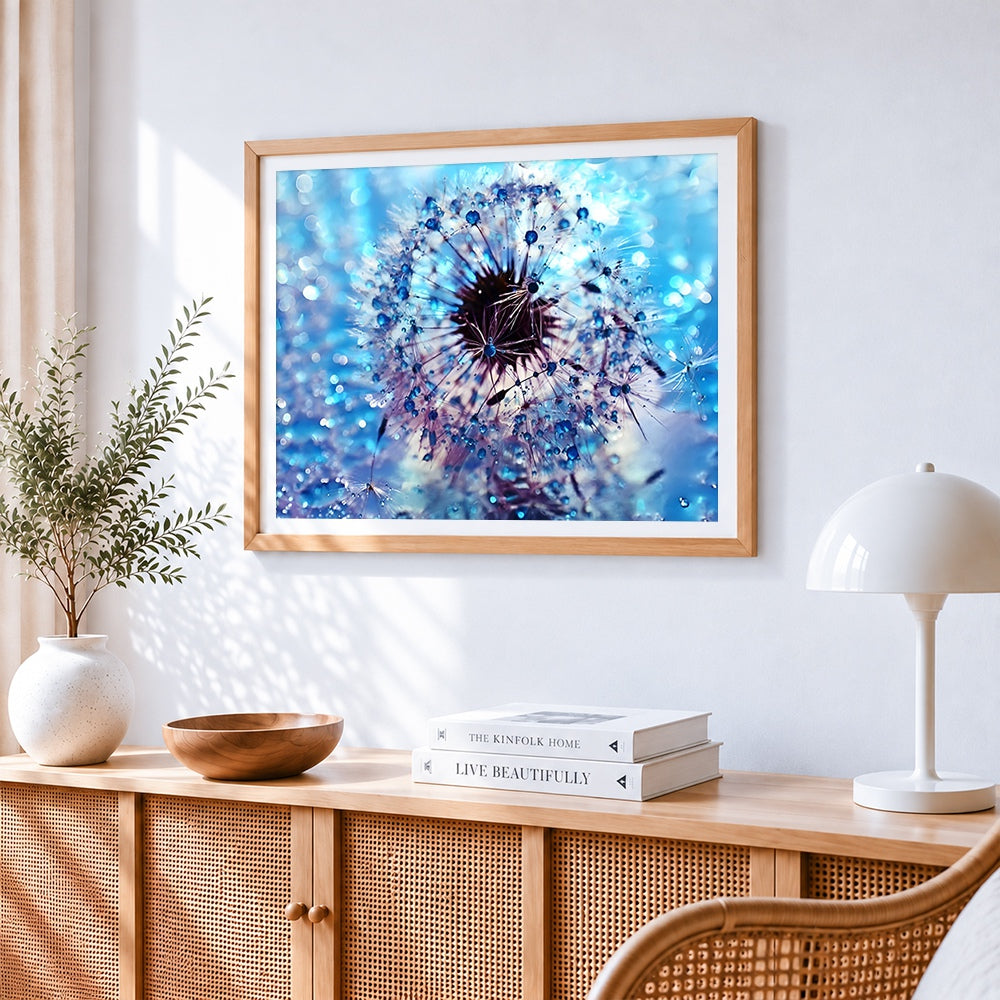Blue dandelion with dew drops cross stitch artwork displayed on wall as home decor