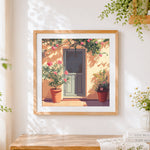 Finished blue door and pink oleander cross stitch artwork displayed