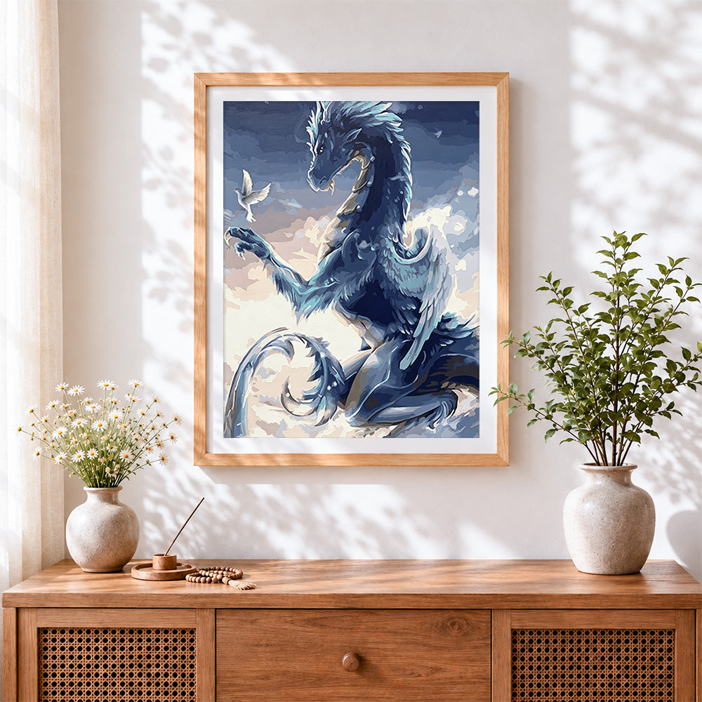 Finished blue dragon and white dove cross stitch artwork displayed