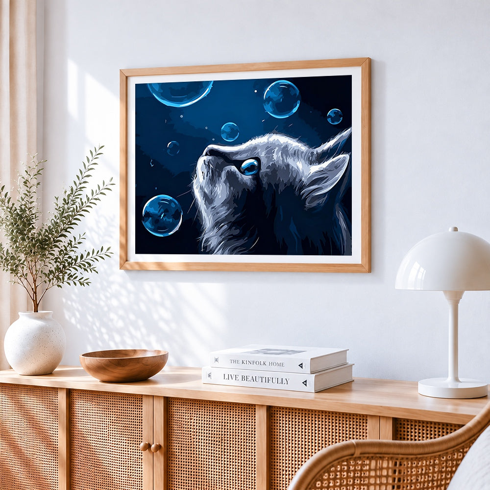 Blue eyed cat with bubbles cross stitch artwork displayed on wall as home decor
