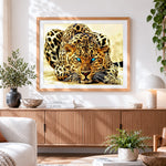 Finished blue eyed leopard cross stitch artwork displayed