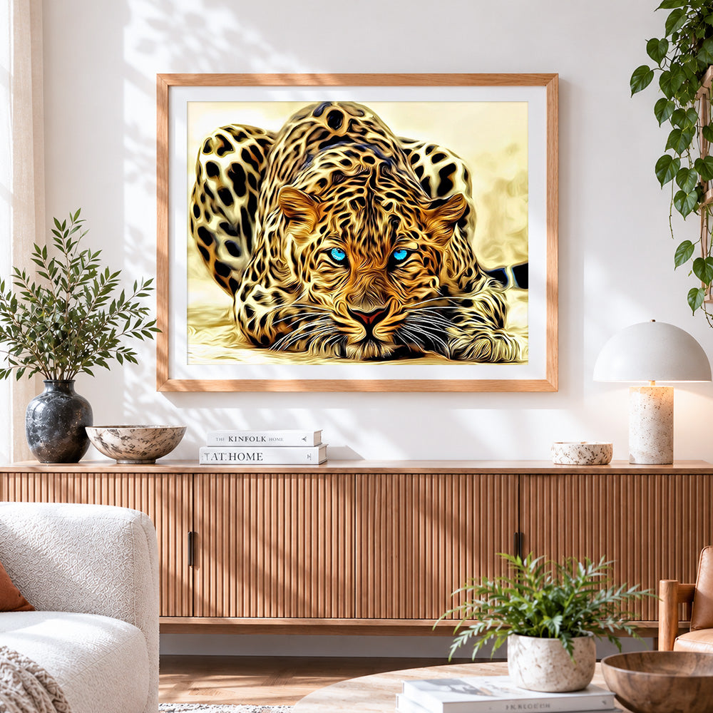 Finished blue eyed leopard cross stitch artwork displayed
