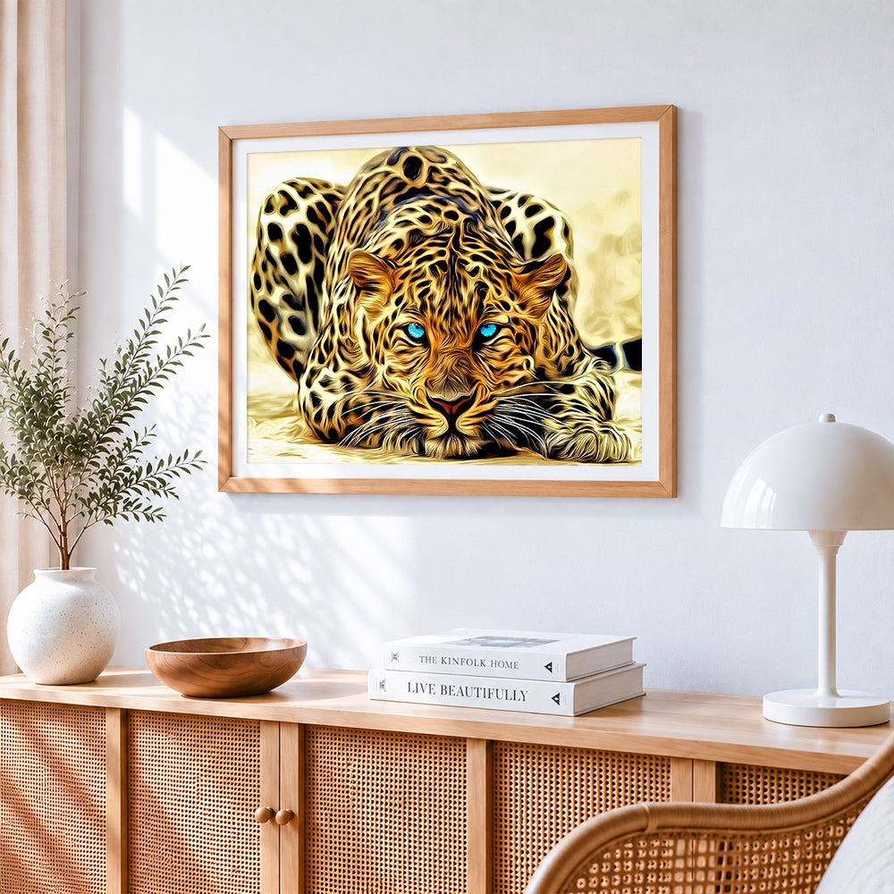 Blue eyed leopard cross stitch artwork displayed on wall as home decor