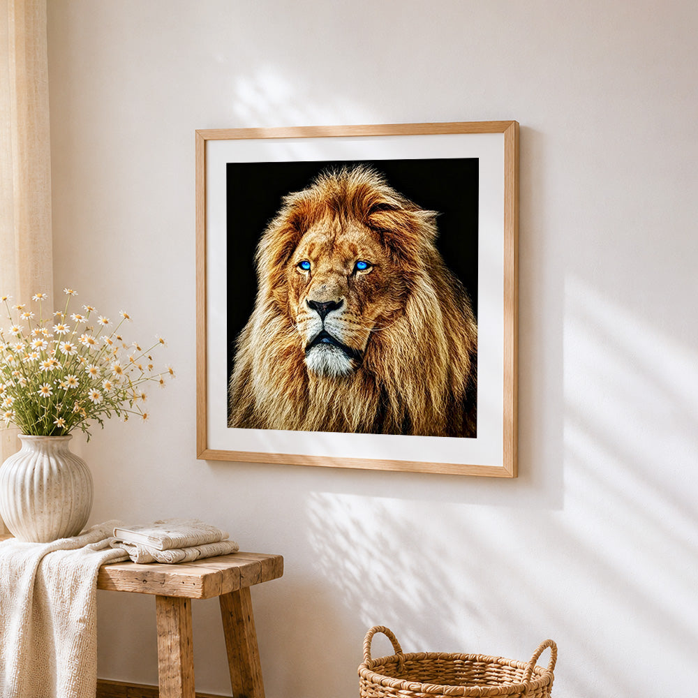 Blue eyed male lion cross stitch artwork displayed on wall as home decor