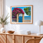 Blue gate with bougainvillea cross stitch artwork displayed on wall as home decor