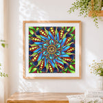 Finished blue green and red floral mandala cross stitch artwork displayed