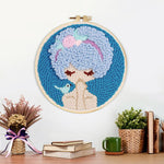 Finished blue haired girl with bird artwork displayed on a wall