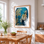 Blue haired woman with gold sun cross stitch artwork displayed on wall as home decor