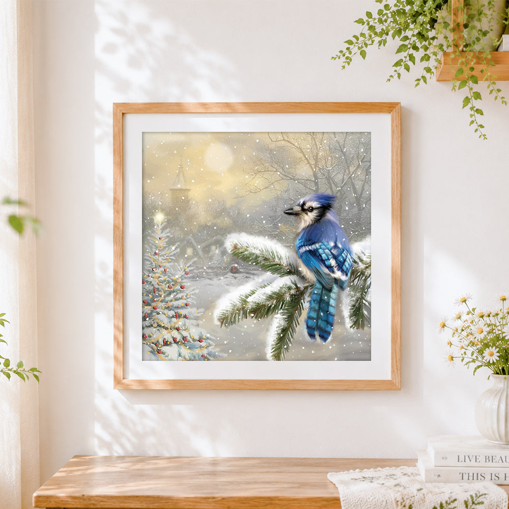 Finished blue jay in snow cross stitch artwork displayed