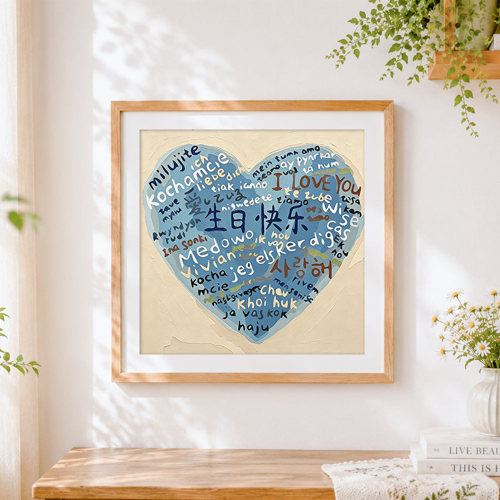 Finished blue multi language heart cross stitch artwork displayed