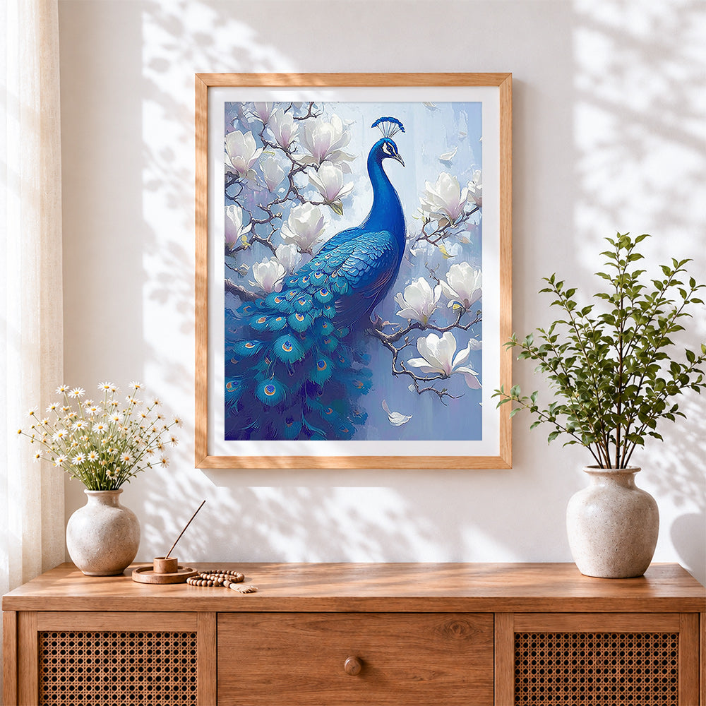 Finished blue peacock on magnolia branch cross stitch artwork displayed