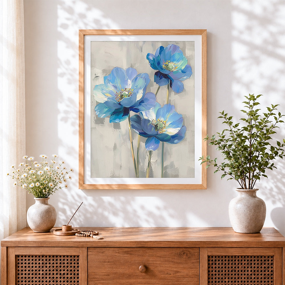 Finished blue poppies on neutral background cross stitch artwork displayed