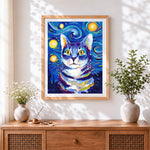 Finished blue starry night cat cross stitch artwork displayed