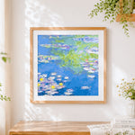 Finished blue water lily pond cross stitch artwork displayed