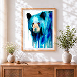 Finished blue watercolour bear cross stitch artwork displayed