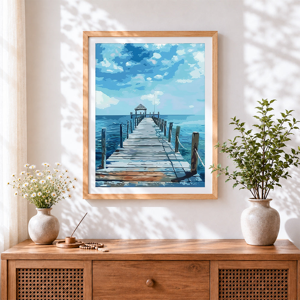 Finished blue wooden pier over calm ocean cross stitch artwork displayed