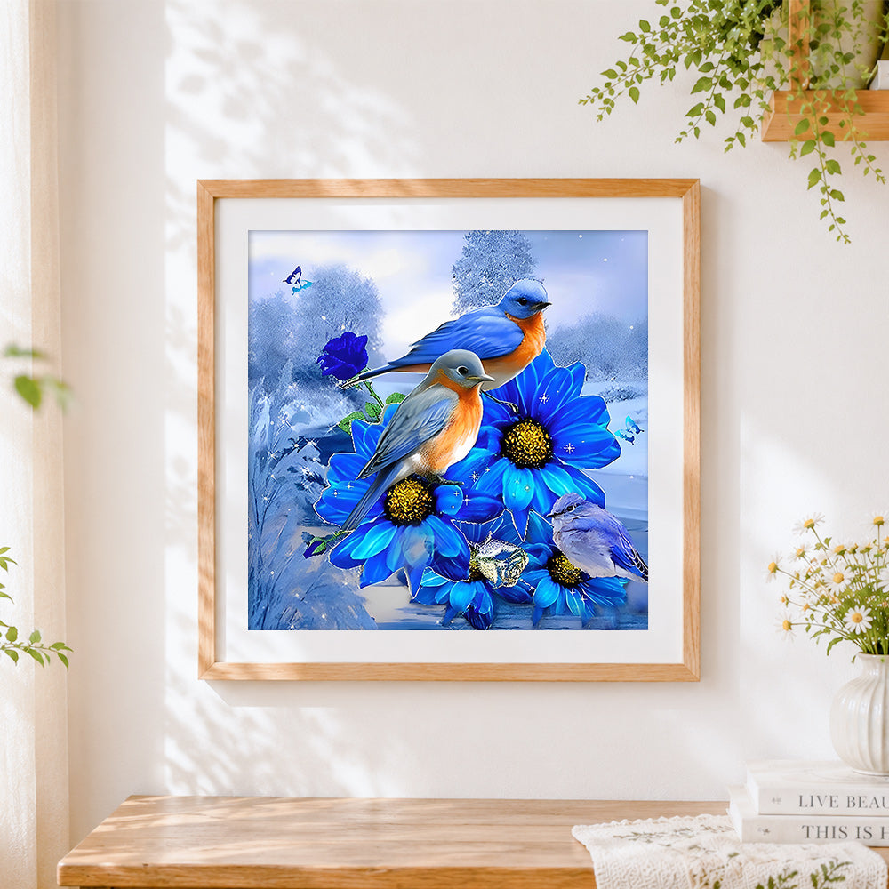 Finished bluebirds and blue flowers cross stitch artwork displayed