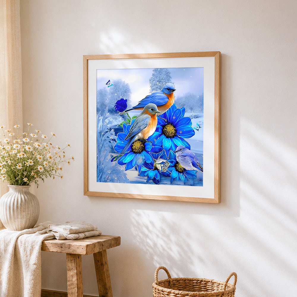 Bluebirds and blue flowers cross stitch artwork displayed on wall as home decor