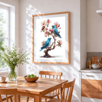 Bluebirds on a blossom tree cross stitch artwork displayed on wall as home decor
