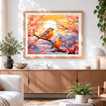 Finished bluebirds on a cherry blossom branch at sunset cross stitch artwork displayed