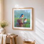 Bluebirds on a rustic fence cross stitch artwork displayed on wall as home decor