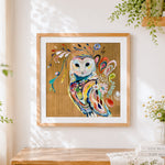 Finished boho floral owl cross stitch artwork displayed