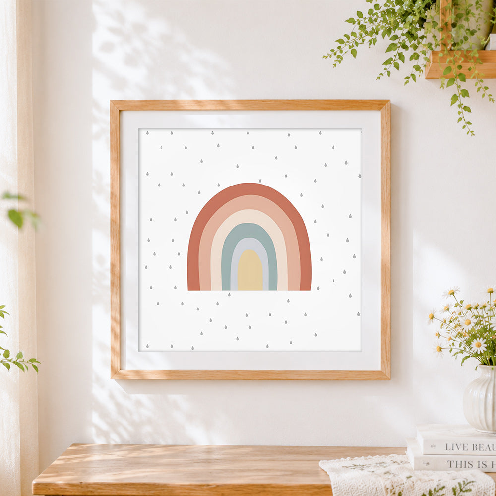 Finished boho pastel rainbow and raindrops cross stitch artwork displayed