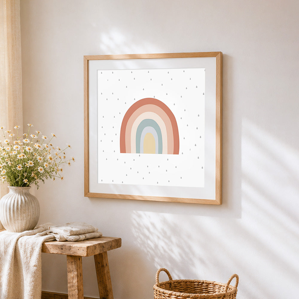 Boho pastel rainbow and raindrops cross stitch artwork displayed on wall as home decor