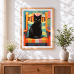 Finished bold black cat in orange armchair cross stitch artwork displayed