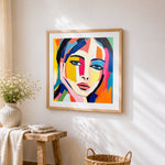 Bold geometric abstract face cross stitch artwork displayed on wall as home decor