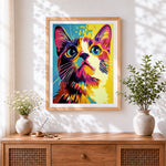 Finished bold pop art cat face cross stitch artwork displayed