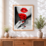 Finished bold red lips and rose cross stitch artwork displayed