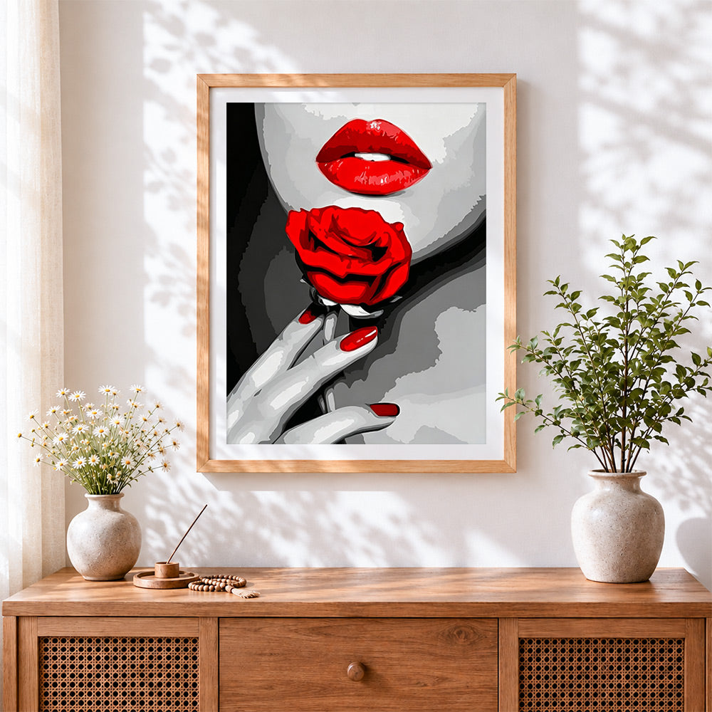 Finished bold red lips and rose cross stitch artwork displayed