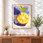 Finished bright lemon slice cross stitch artwork displayed