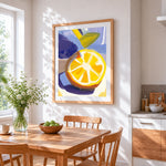 Bright lemon slice cross stitch artwork displayed on wall as home decor