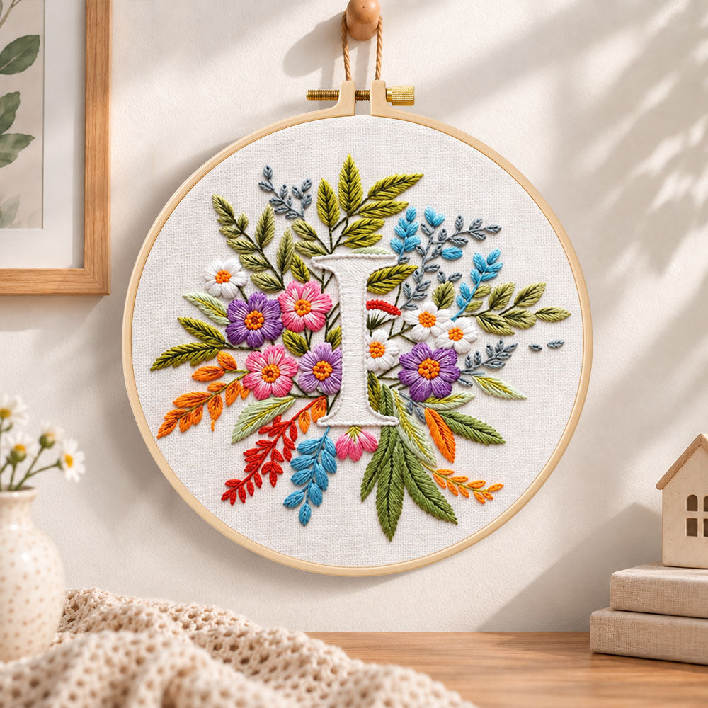 Bright mixed petals and letter i embroidery hoop wall art displayed as warm and cosy handmade home decor