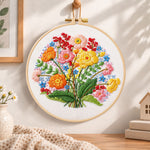 Bright wildflower cluster embroidery hoop wall art displayed as warm and cosy handmade home decor