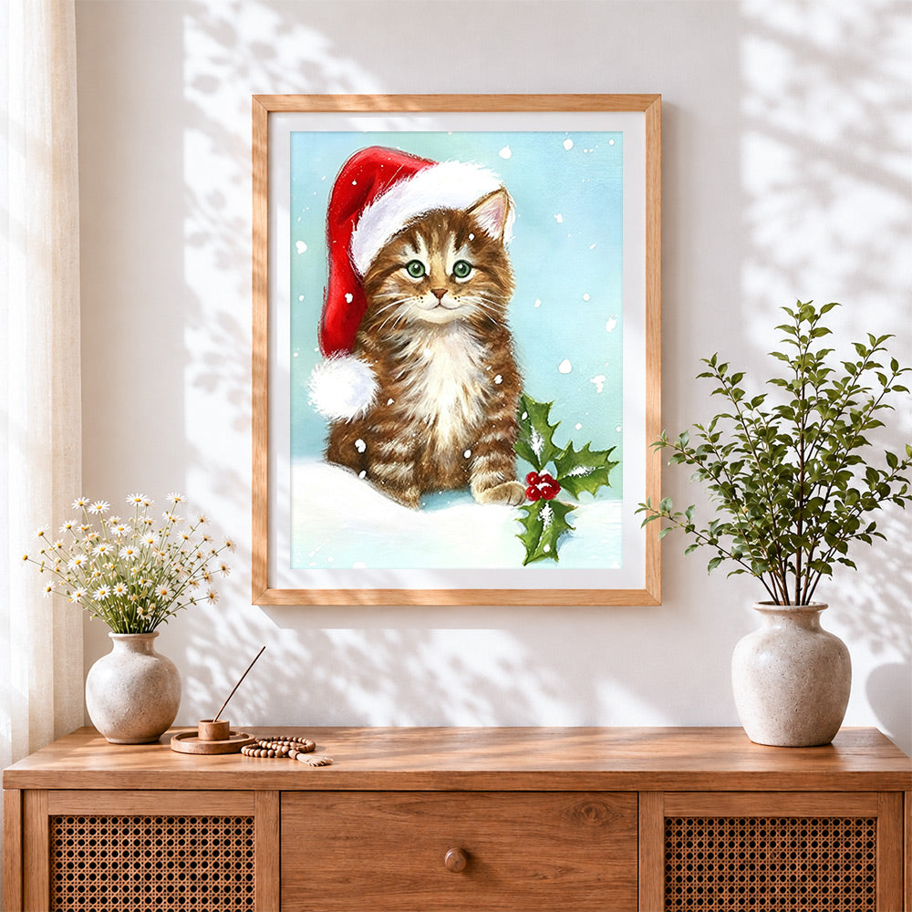 Finished brown tabby kitten in a santa hat cross stitch artwork displayed