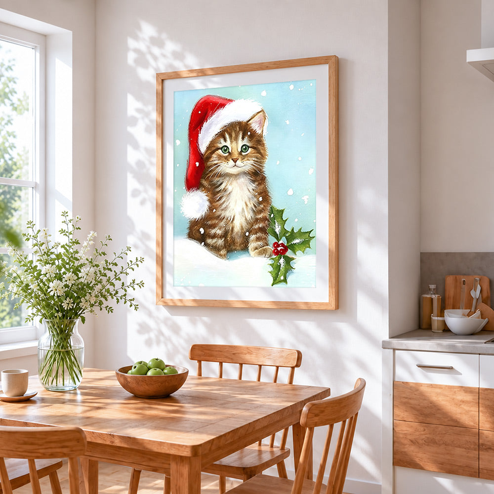 Brown tabby kitten in a santa hat cross stitch artwork displayed on wall as home decor