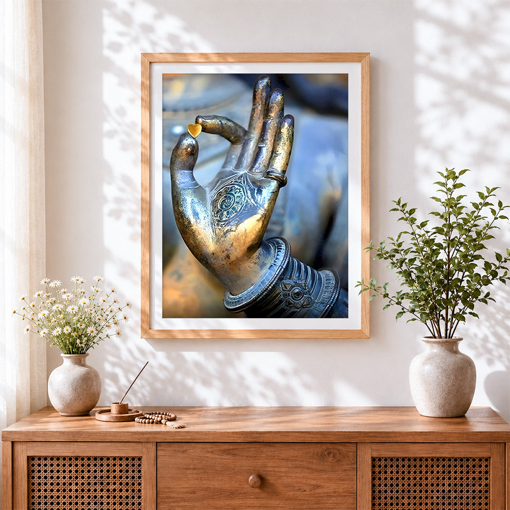 Finished buddha hand holding heart cross stitch artwork displayed
