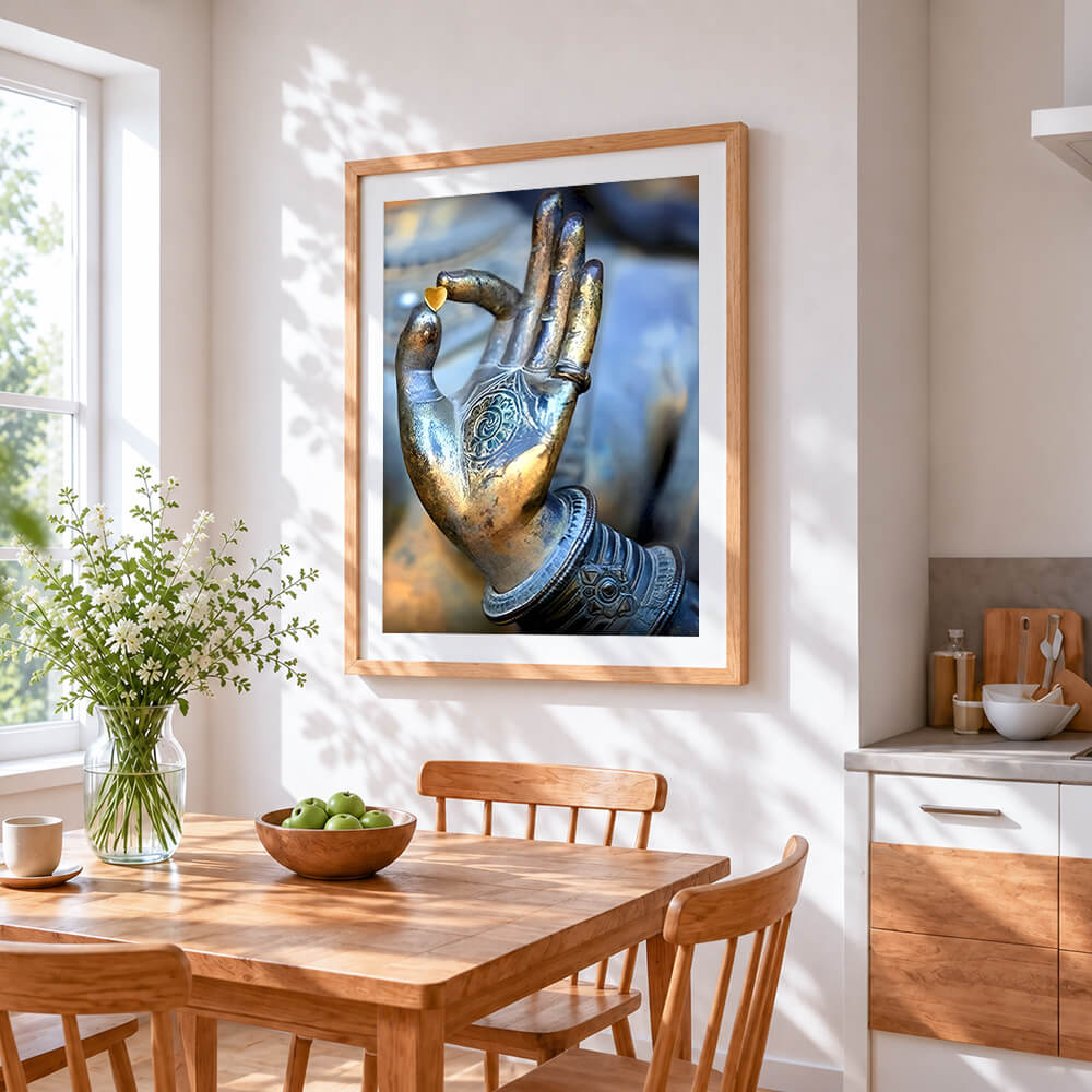 Buddha hand holding heart cross stitch artwork displayed on wall as home decor