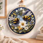 Bumblebees and white daisies embroidery hoop wall art displayed as warm and cozy handmade home decor
