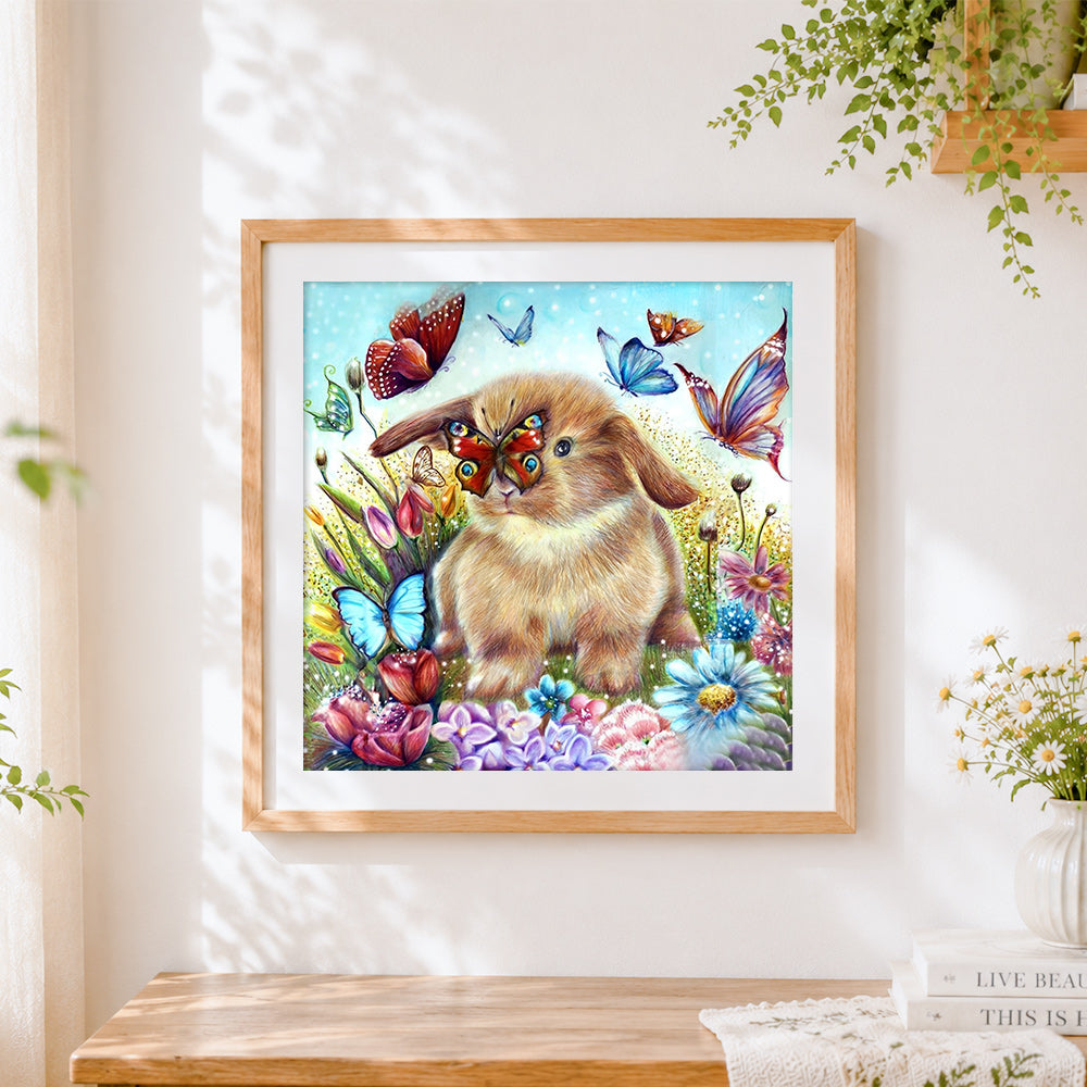 Finished bunny and butterflies in flower garden cross stitch artwork displayed