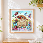 Finished bunny and butterflies in flower garden cross stitch artwork displayed