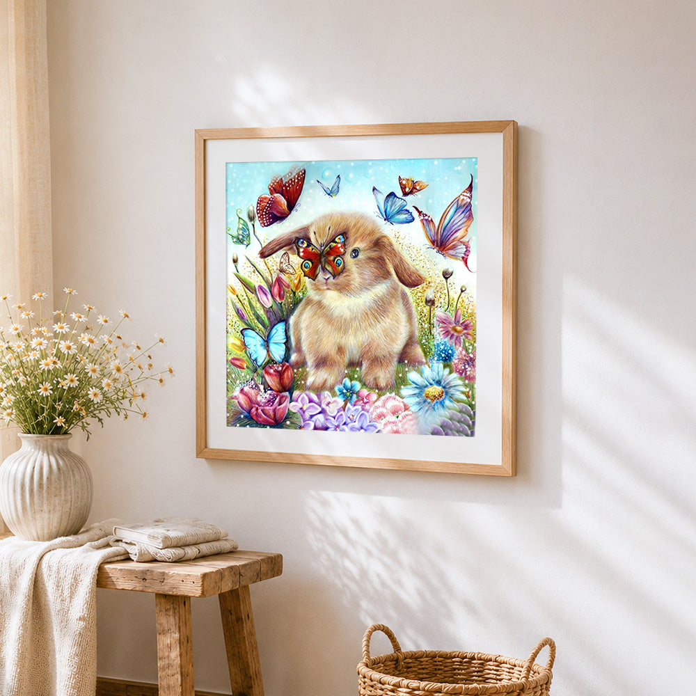 Bunny and butterflies in flower garden cross stitch artwork displayed on wall as home decor