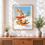 Finished bunny on a sledge with hot chocolate cross stitch artwork displayed