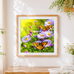 Finished butterflies on purple wildflowers cross stitch artwork displayed